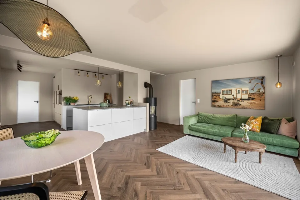 Open living room and kitchen with an island after renovation